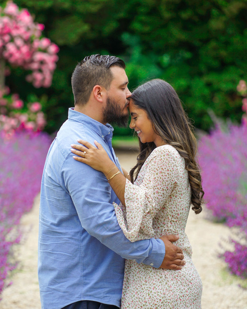 Close portrait of a couple forehead to forehead in a lavender garden